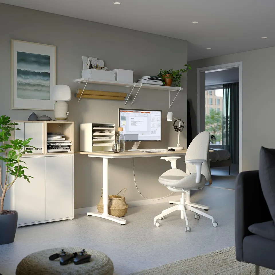 Home office with ergonomic chair, computer setup, grey decor, functional & stylish.