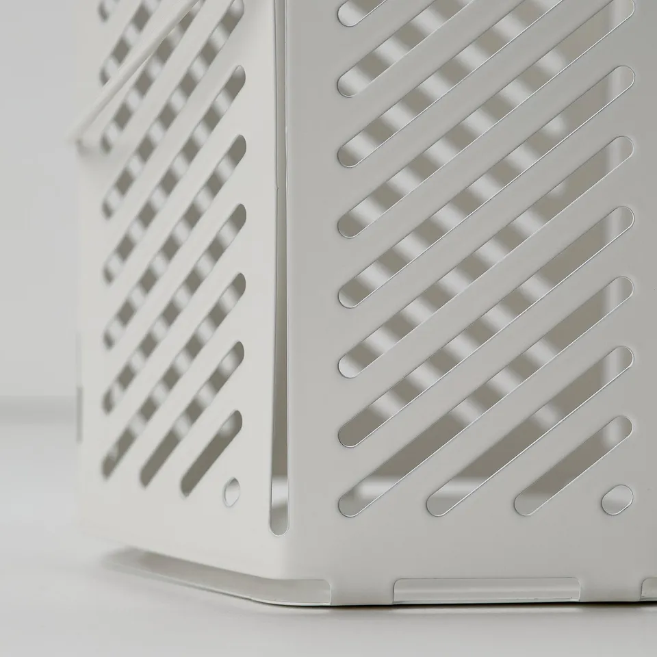 White metal lantern with horizontal slits, stood upright, casting shadows, quality design.