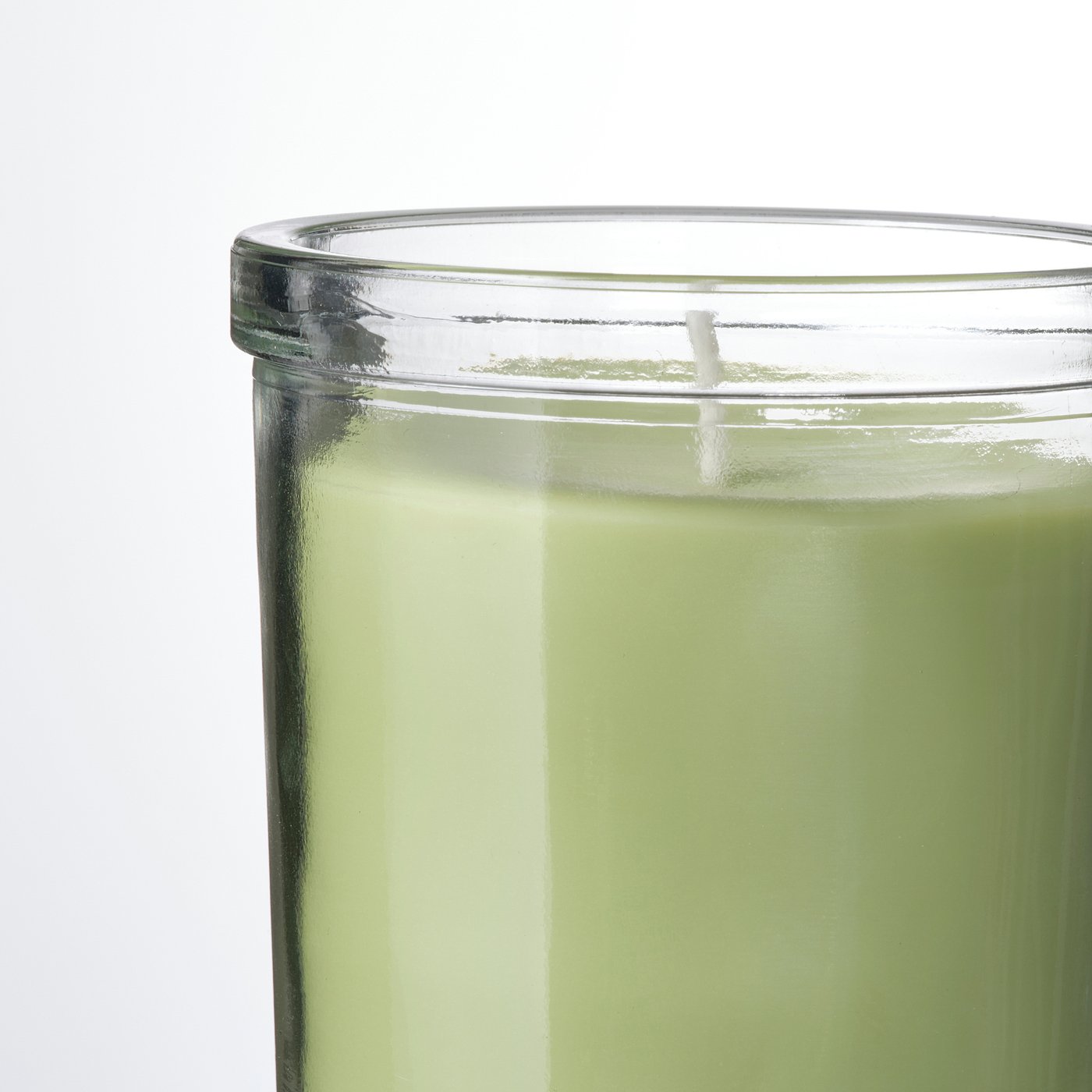 Vibrant green candle in clear glass, brightening room with crisp apple scent.