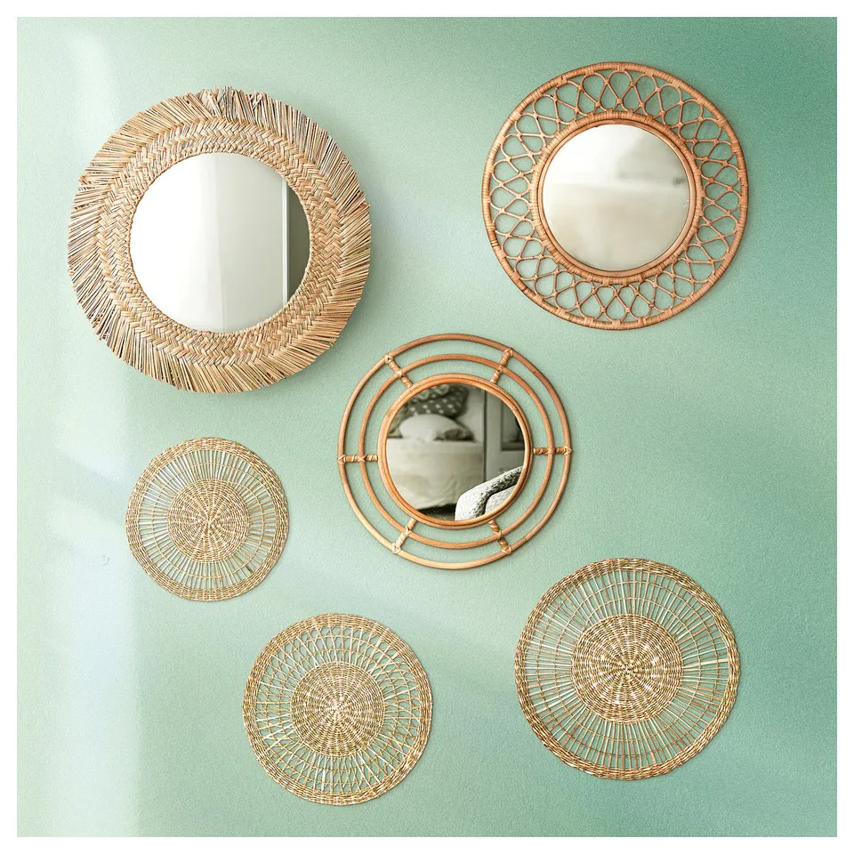 Five rattan mirrors on green wall, natural colour, intricate designs.