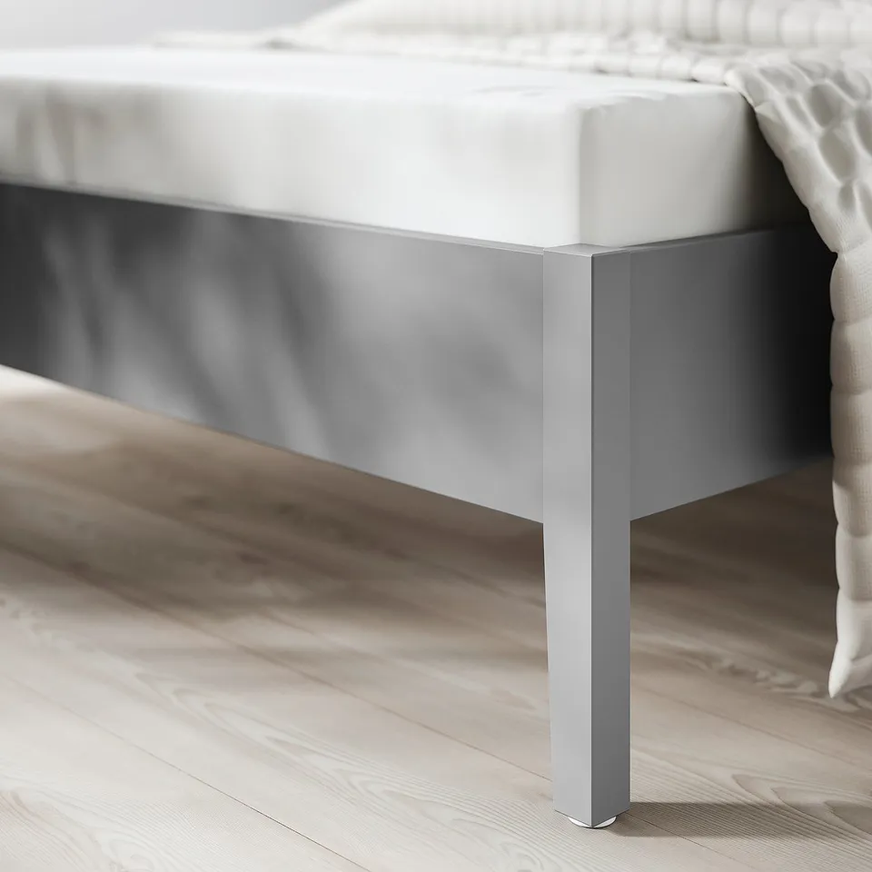 Close-up of a modern beds metallic base, showing its sleek, sturdy design. Highlights the beds crafted feel and robust construction.