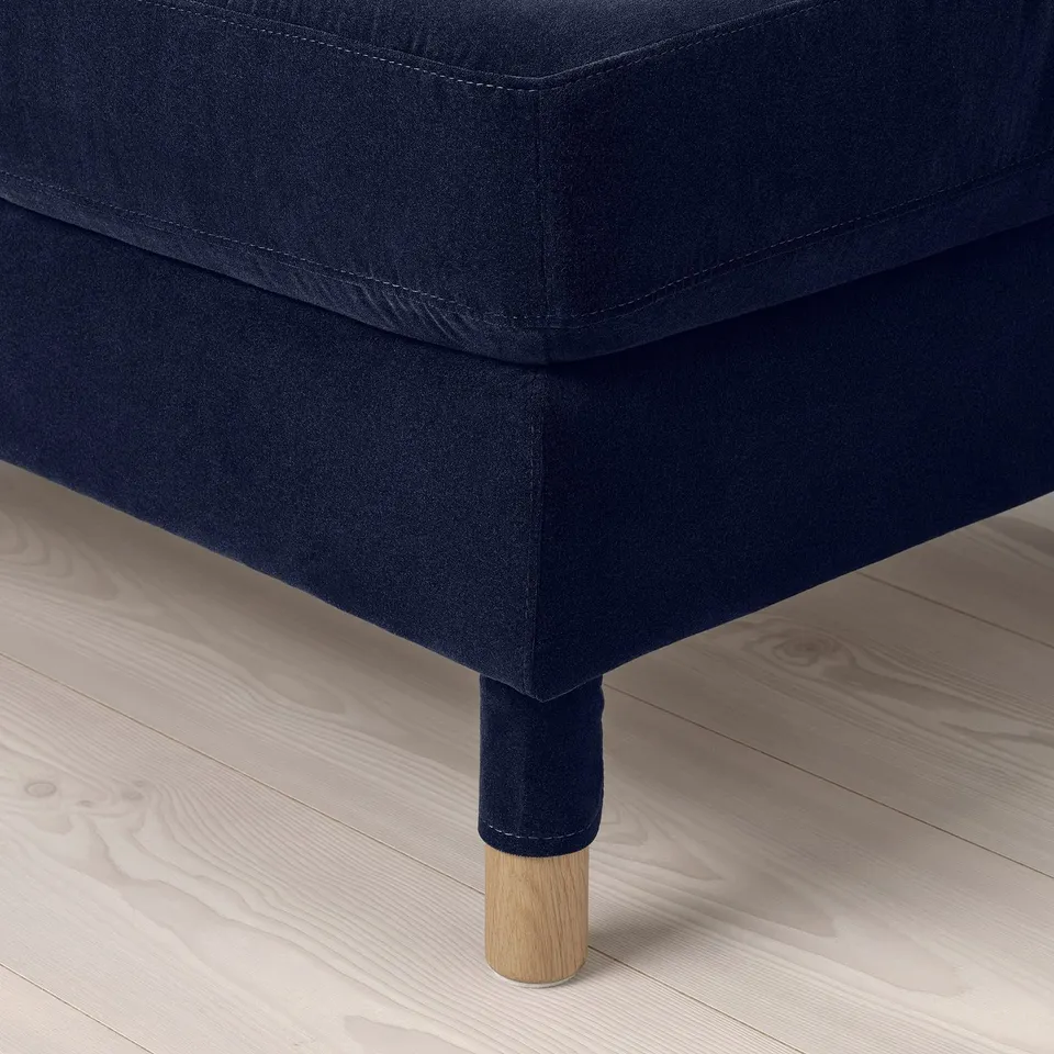 Modern dark sofa with plush cushions and sturdy wooden legs, exuding comfort and quality.