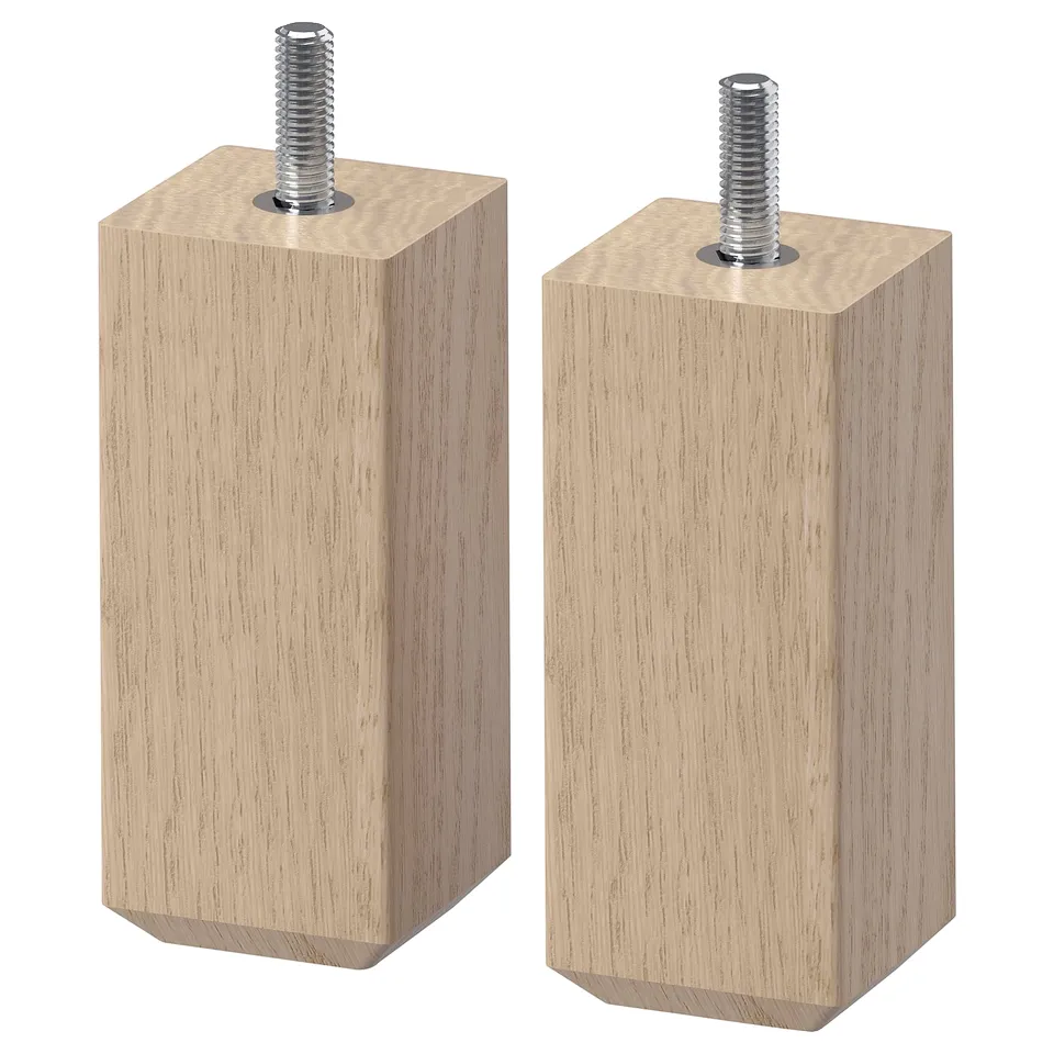 Two light brown wood legs with metal screws on top for furniture.