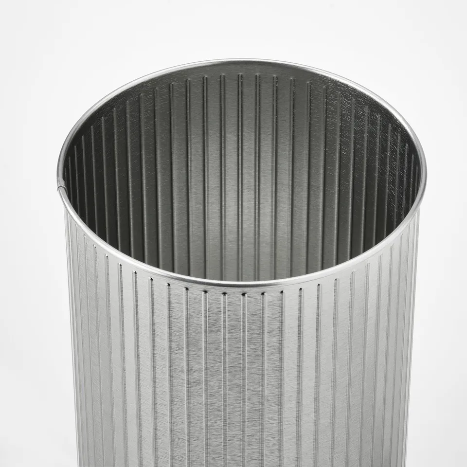 Silver cylindrical tin with vertical grooves, high-quality finish, and sturdy design.
