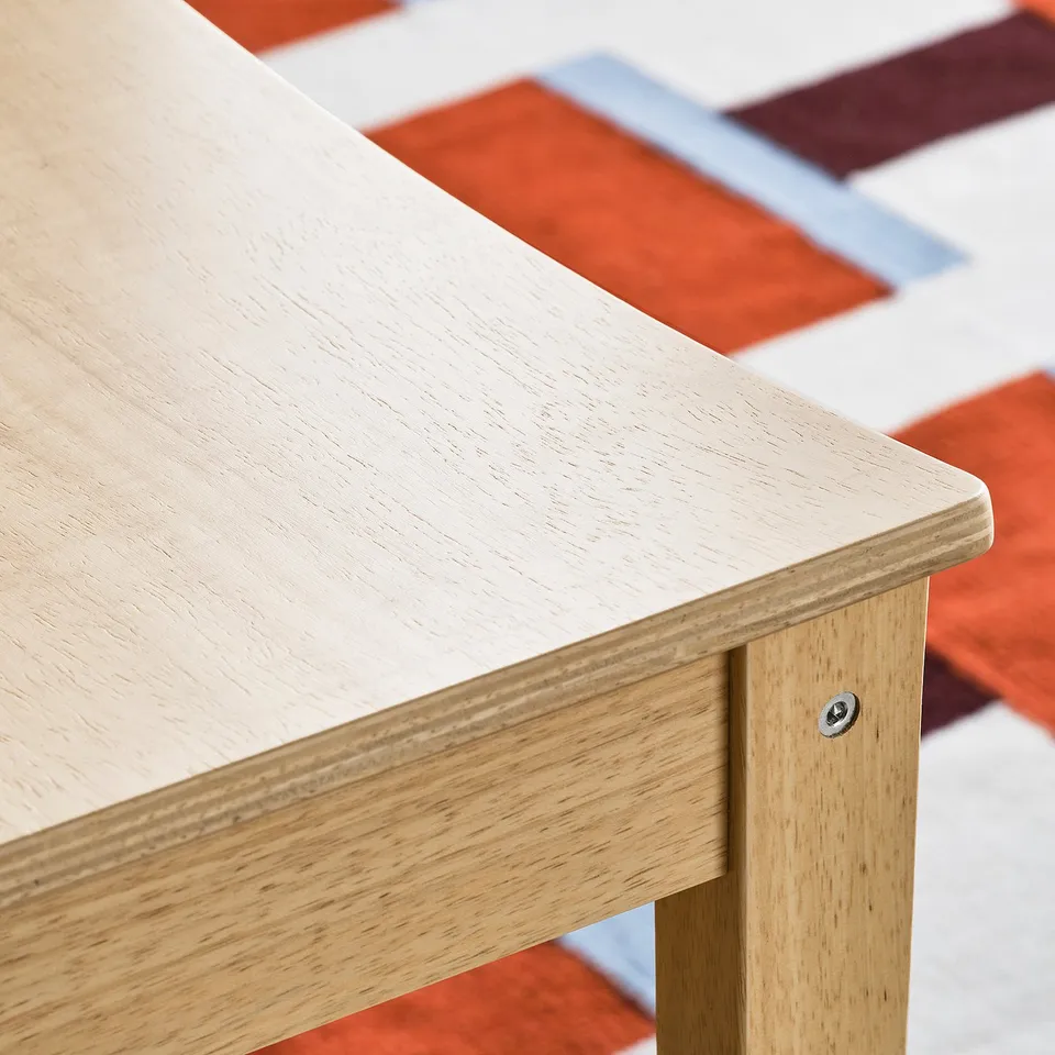 Close-up of sturdy wooden table edge, smooth finish, showcasing quality craftsmanship.