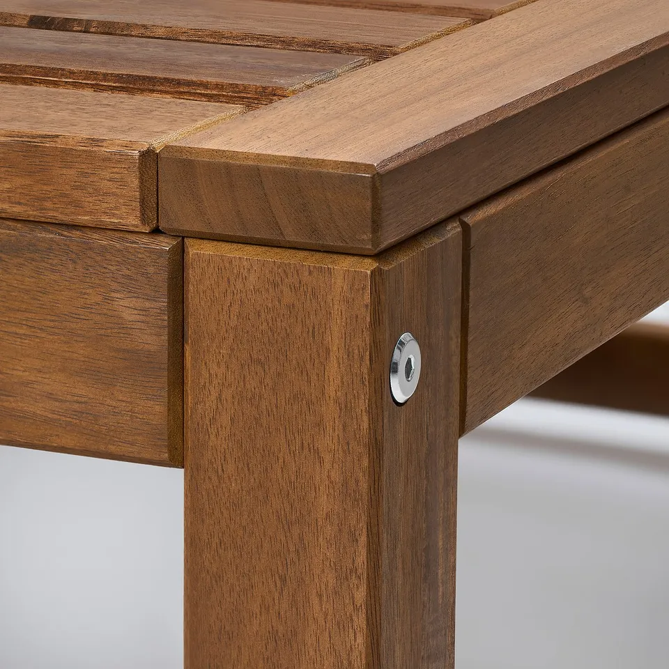 Close-up of sturdy, wooden outdoor furniture; smooth finish, visible craftsmanship, metal connector detail.