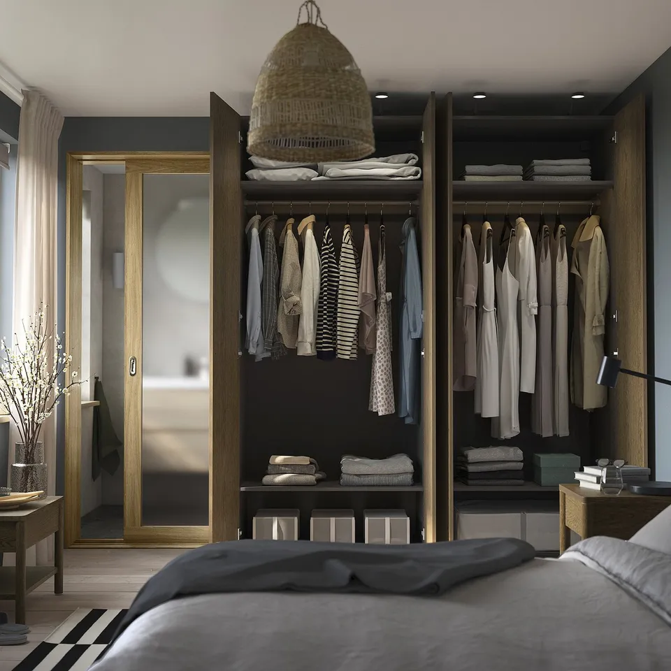 Open wardrobe with clothes & boxes; grey bed, pendant lamp