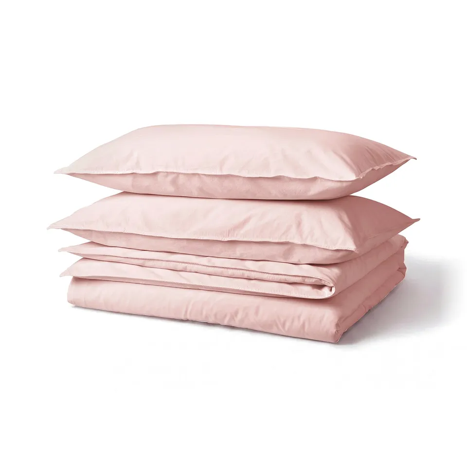 Pink folded bedding set. Includes duvet cover and pillowcases. Made from soft, 100% cotton. Casual, simple design.