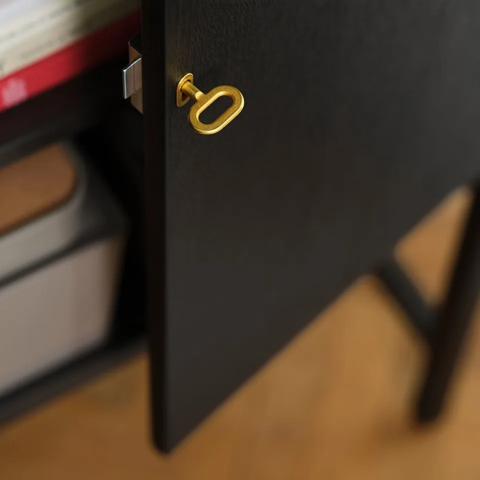 Black cabinet with gold handle, featuring adjustable shelves. High-quality finish and durable hardware for long-lasting use.