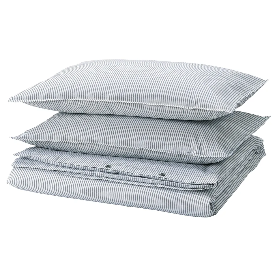 Stack of blue-striped pillows with zip detail, square shape, cotton material.