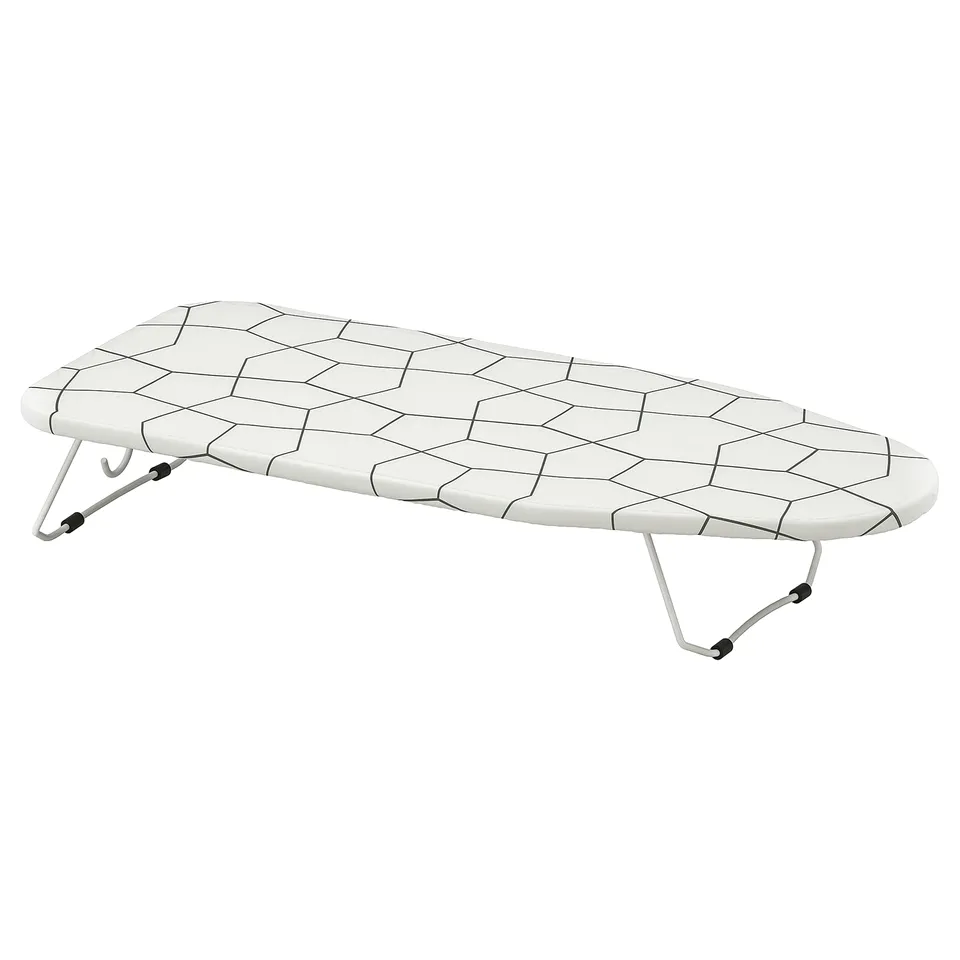 A JÄLL ironing board. Its white with a hexagon-patterned mesh surface. The board has foldable legs and hooks for wall mounting.