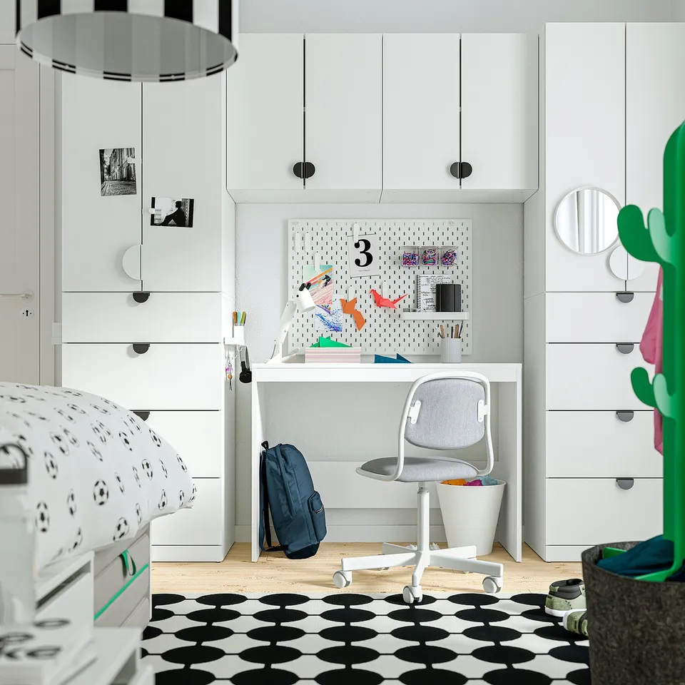 Kids room with white ALTARLIDEN hook rack, holding colourful items between wardrobes.