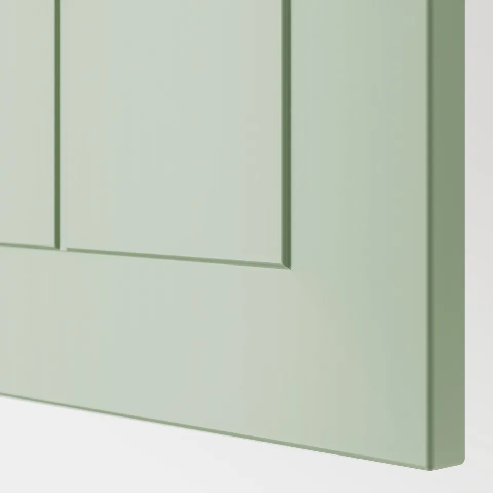 Close-up of durable, green kitchen cabinet; smooth, flush design with sturdy construction.