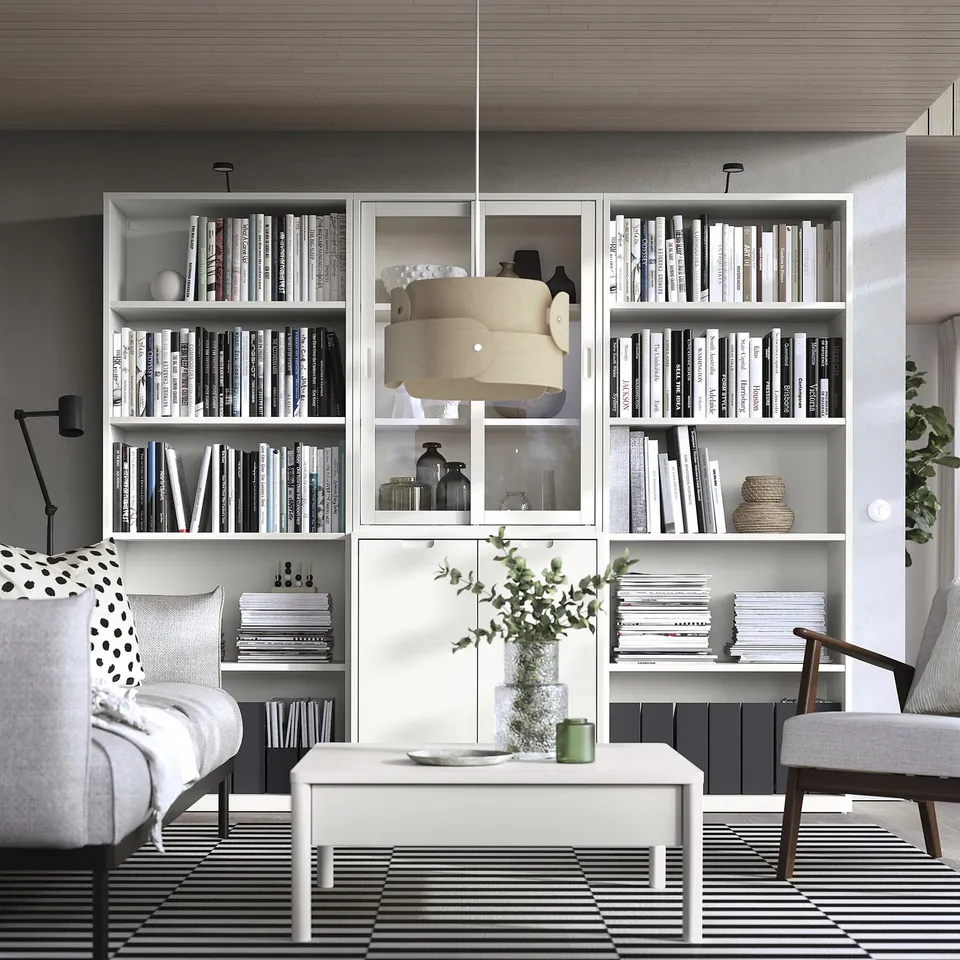 Contemporary living room with TONSTAD furniture, books, decor, soft lighting, comfort.