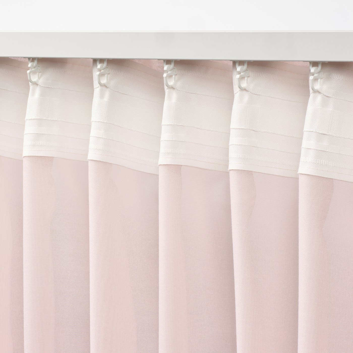 Curtain with heading tape and hooks, diffusing daylight and offering privacy.