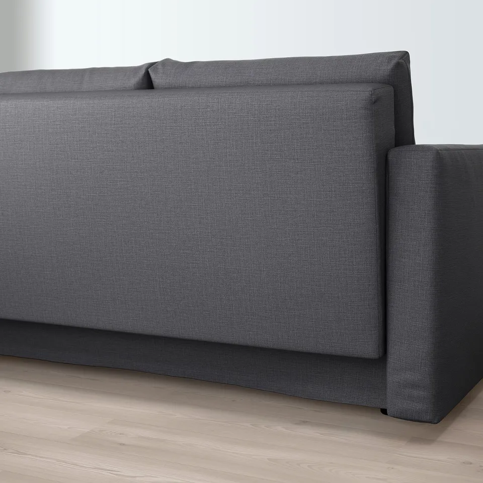 Close-up of a modern grey convertible sofa with built-in storage, positioned on a light wooden floor.