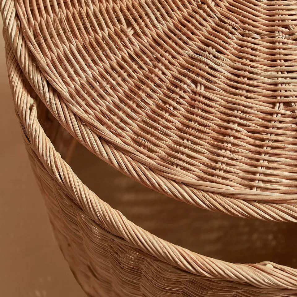 Close-up of tightly woven natural rattan basket, showcasing intricate craftsmanship and quality texture.