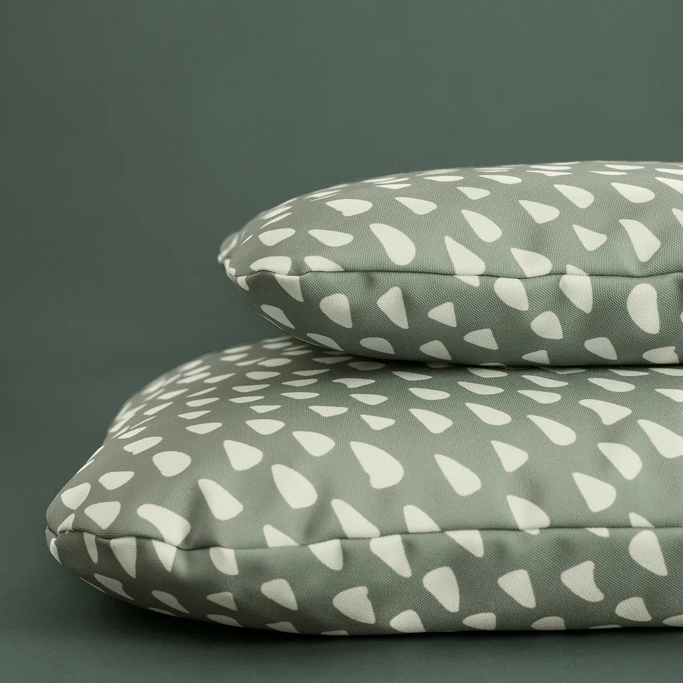 Two pet cushions with white abstract shapes on grey fabric, designed for pets to relax and sleep on.