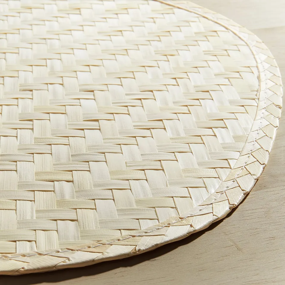 Handwoven pentagon place mat, intricate natural texture, smooth surface, crafted from palm leaf.