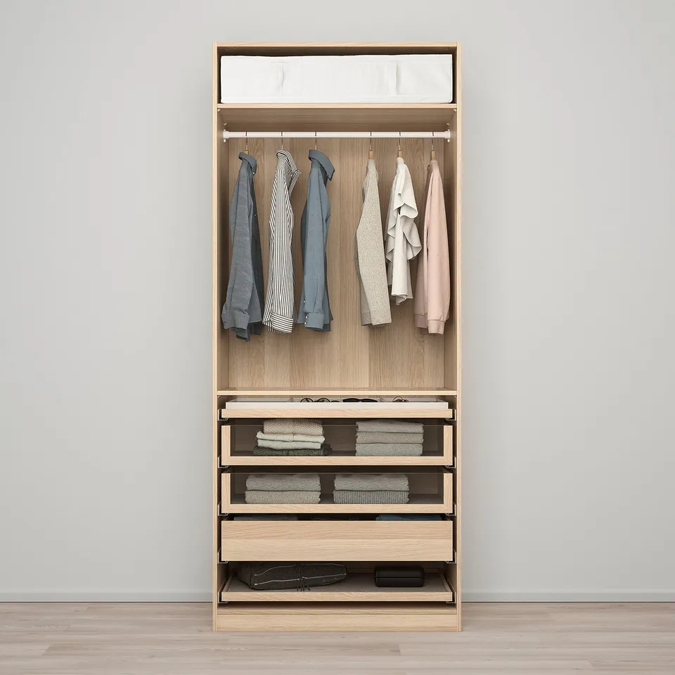 Wooden wardrobe with hanging clothes, shelves, and drawers organised for storage and display.