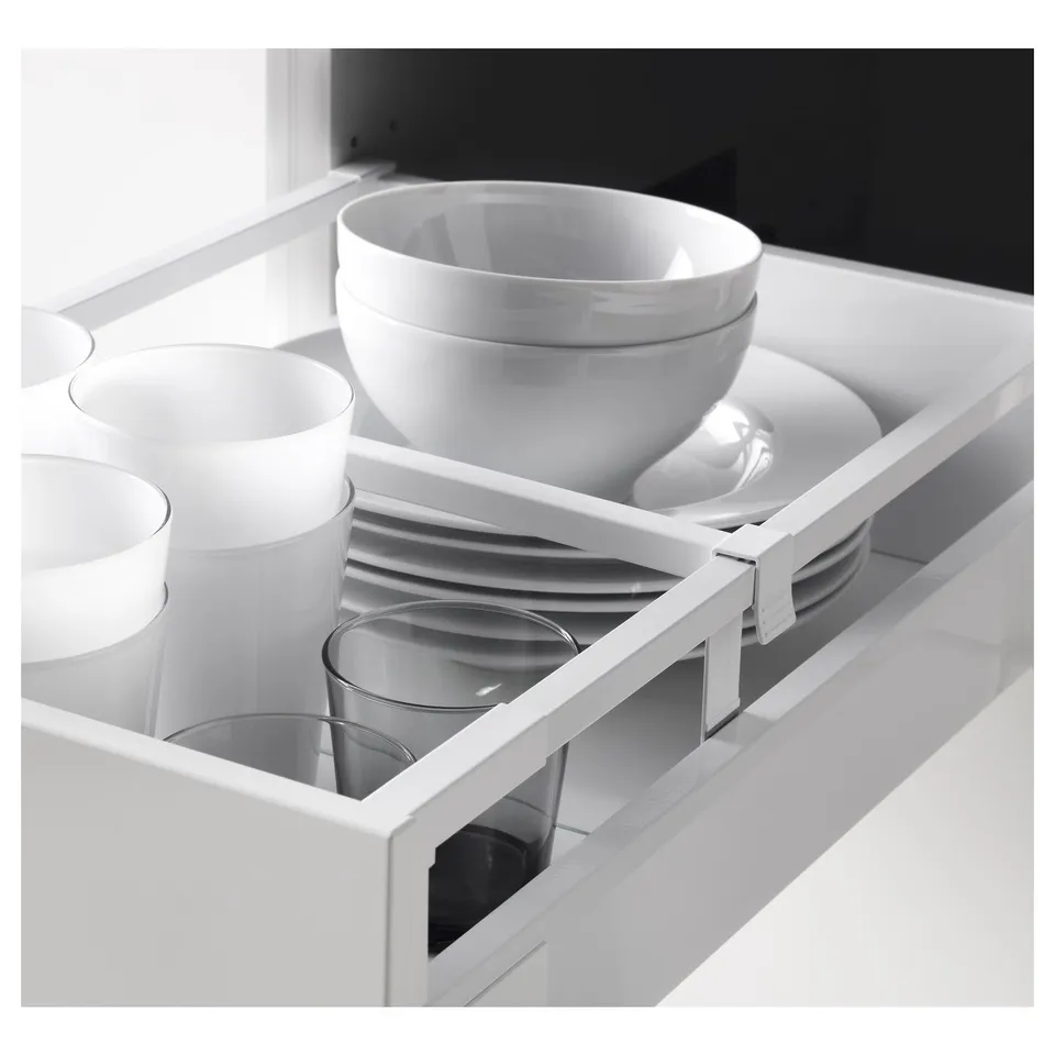 Kitchen drawer with adjustable shelves showing plates, cups, and bowls.