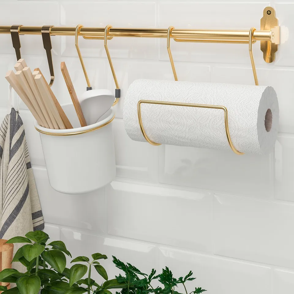 A kitchen rail system with a paper towel holder and utensil caddy for space-saving and organisation, featuring a traditional aesthetic.
