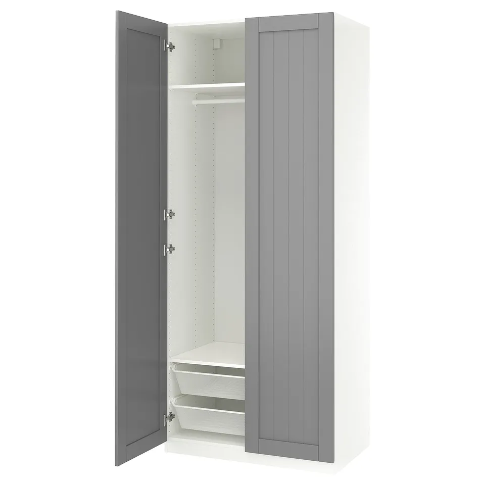 A white and grey PAX wardrobe with one door open, revealing metal mesh baskets.