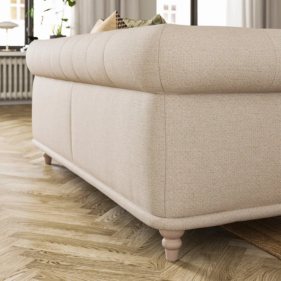 A beige VISKAFORS sofa in a cosy room. Its rounded shape and soft upholstery invite comfort.