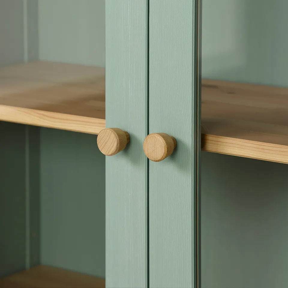 Close-up of stylish cabinet doors with wooden knobs, showing quality craftsmanship and finish.
