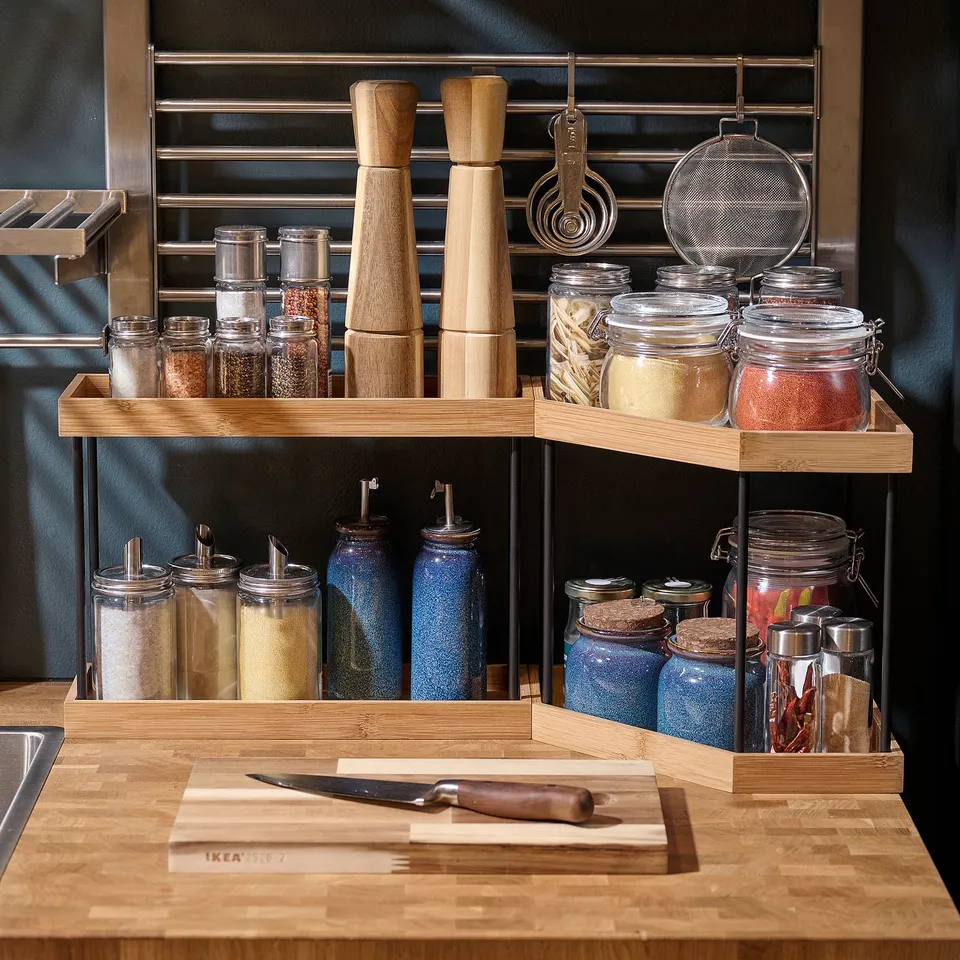 Organised kitchen corner shelf with jars and mills.