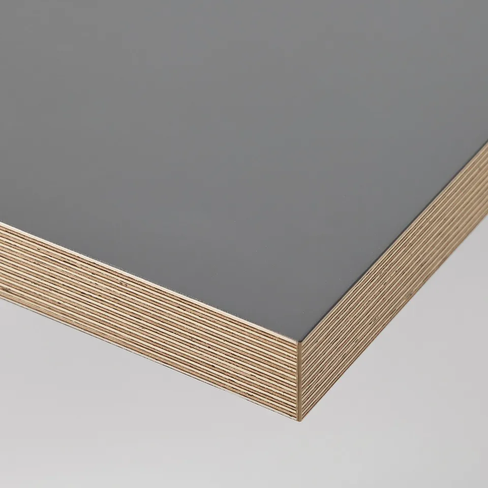 Modern desk with sleek, dark top and honeycomb-patterned edge banding, showcasing quality craftsmanship.