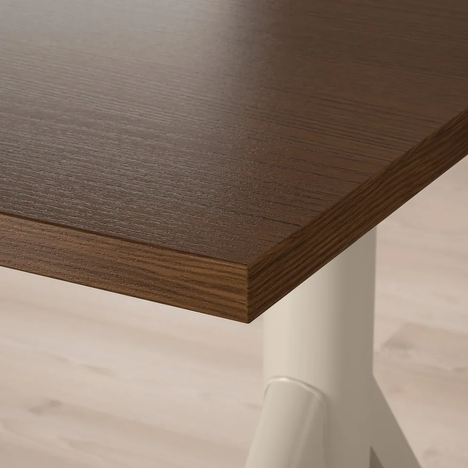 Close-up of a dark wood desk edge, showcasing smooth, natural veneer texture and sturdy design.