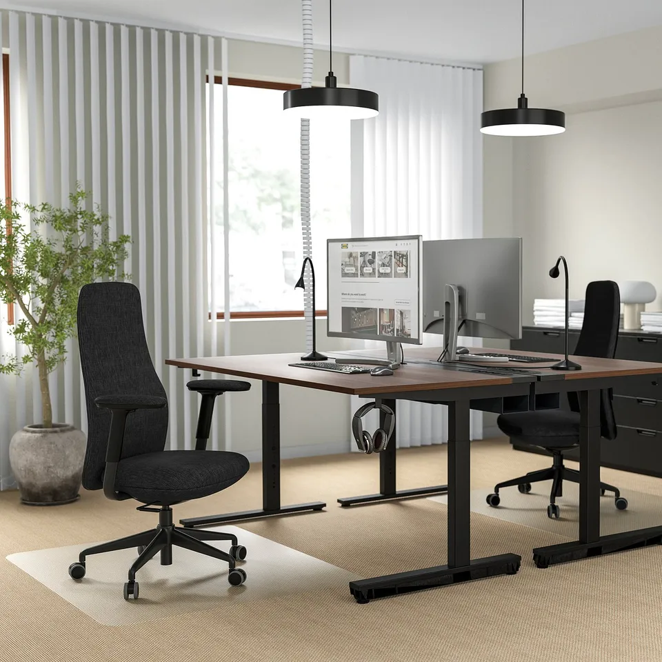 Modern office with GRÖNFJÄLL chair, dual monitors, natural light, and ergonomic design.