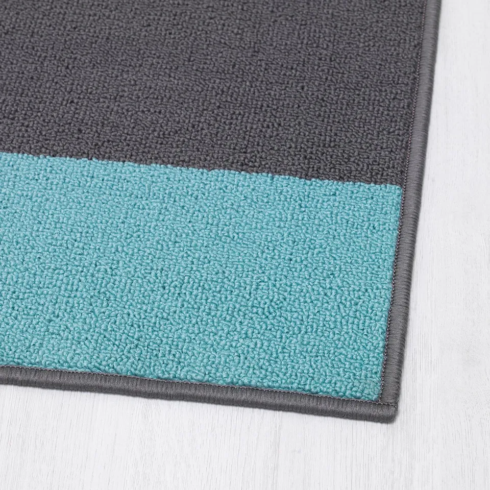 Two-toned blue and grey door mat with strong rubber backing.
