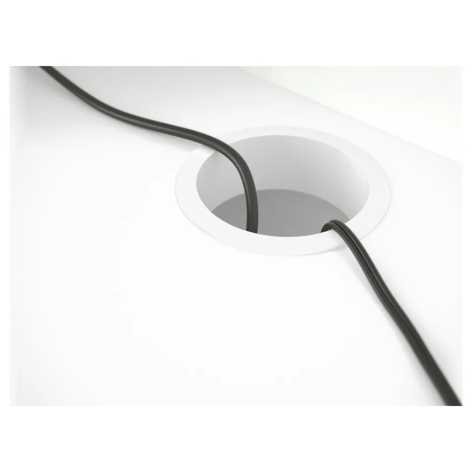 Cable outlet at back of desk keeps cables organised, seen here with a black cord.