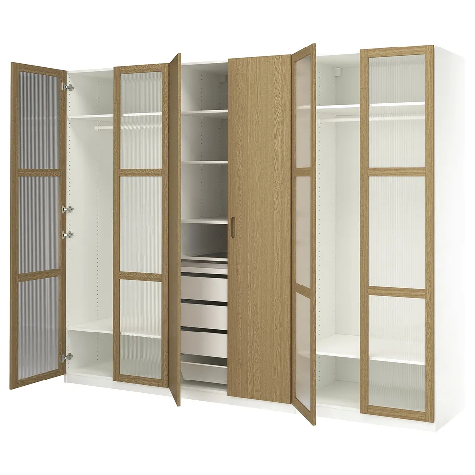 Modern PAX wardrobe in oak and white, featuring open and closed sections, shelves, and drawers for storage.