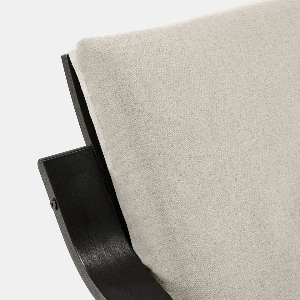 Close-up of sleek, modern chair with curved black metal base and minimalist light grey cushion.