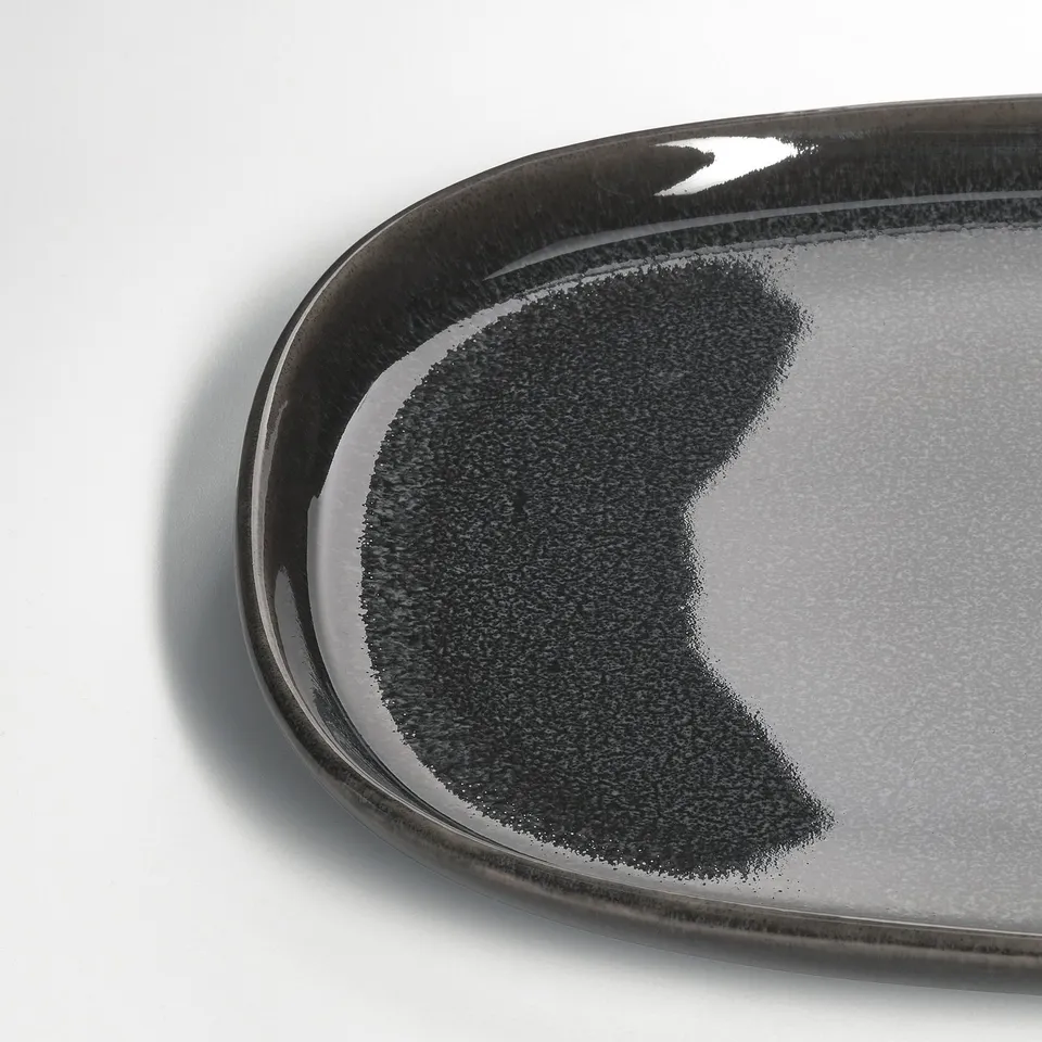 Dark grey glazed plate, smooth edges, textured surface, high-quality stoneware.