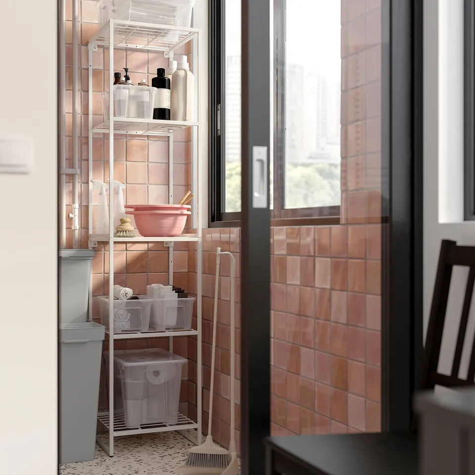 Small organising shelf in bathroom, white JOSTEIN by IKEA, holds cleaning supplies and towels, durable powder-coated steel.