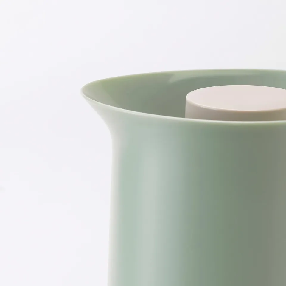 Green vacuum flask, durable, easy pour.