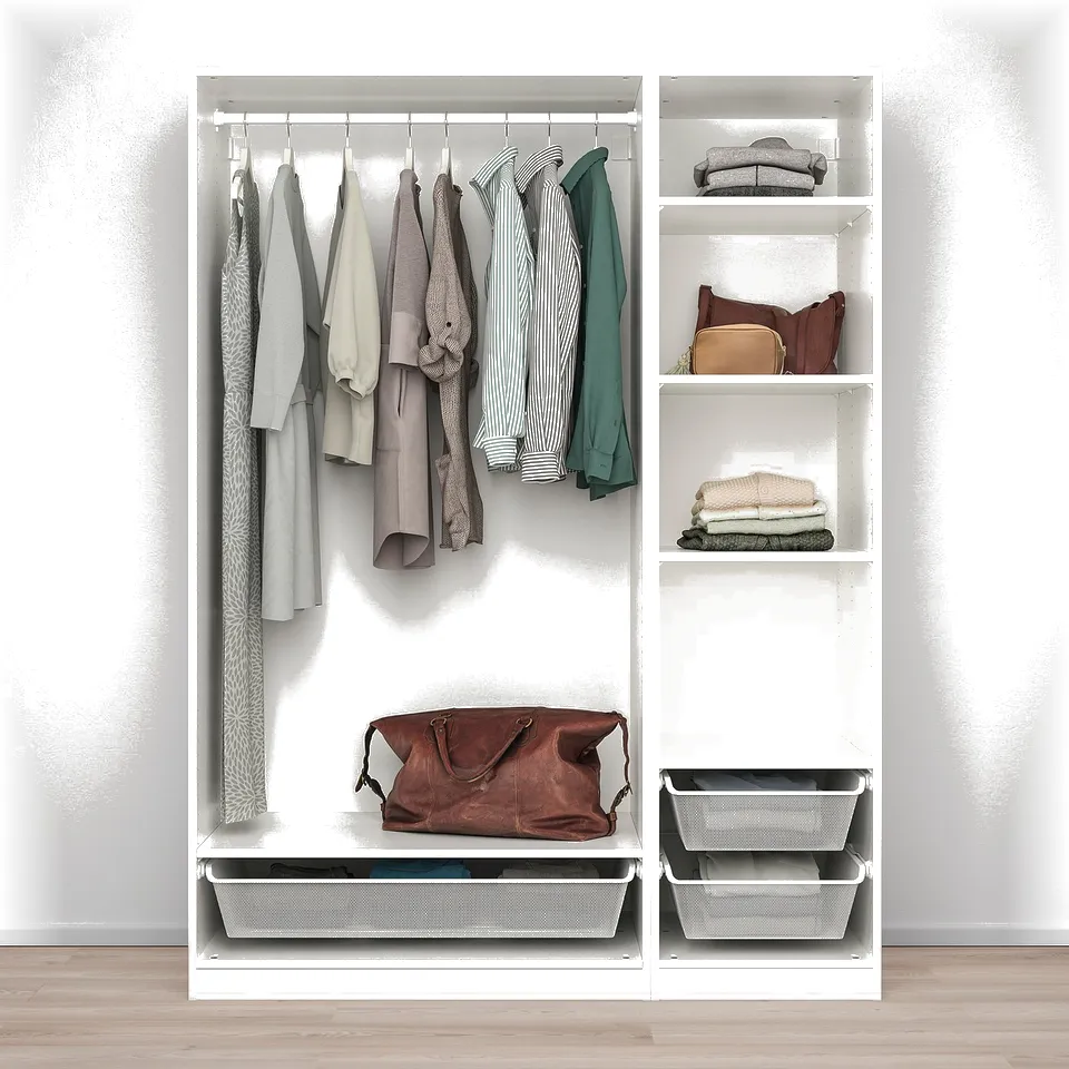 A white PAX wardrobe stores clothes on hangers, shelves, and baskets, offering organised storage space.