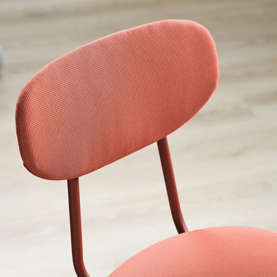 Red upholstered chair with metal legs, showcasing modern design and quality fabric.