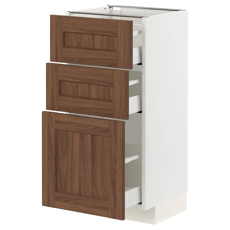 White METOD kitchen unit with walnut drawers and pull-out shelves.