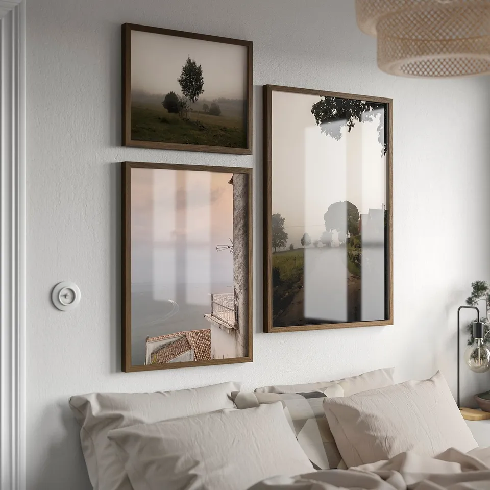 Three framed nature photos above bed, vintage style.