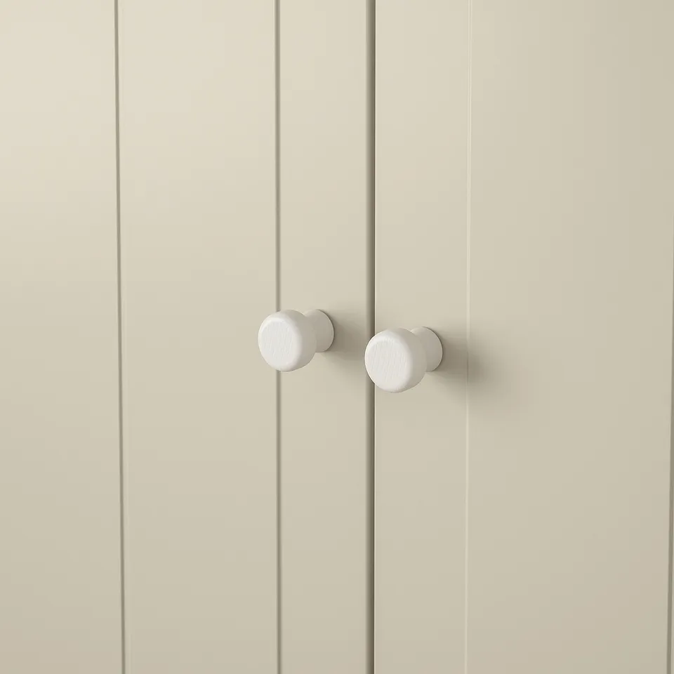 Double door knobs, sleek and modern design. White coating, securely attached. Ideal for contemporary décor.