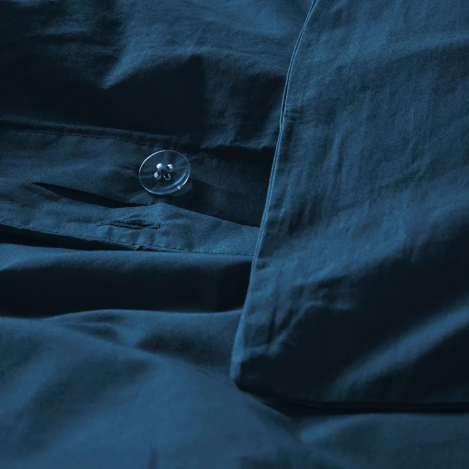 Dark blue duvet cover with visible button.