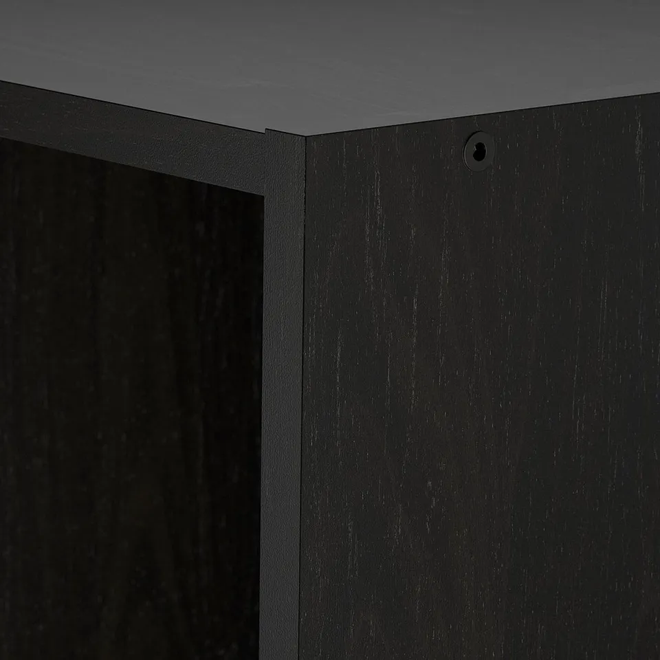 Black wooden shelf showing smooth finish and precise craftsmanship.