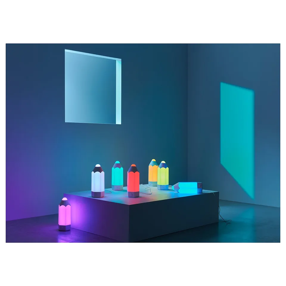 Colourful plastic lamps on table, various designs. Since the original is already within the character limit, it doesnt need to be shortened further.