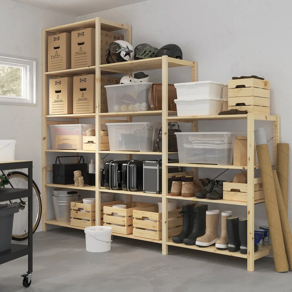Large IVAR pine storage unit with shelves and containers beside a bicycle.