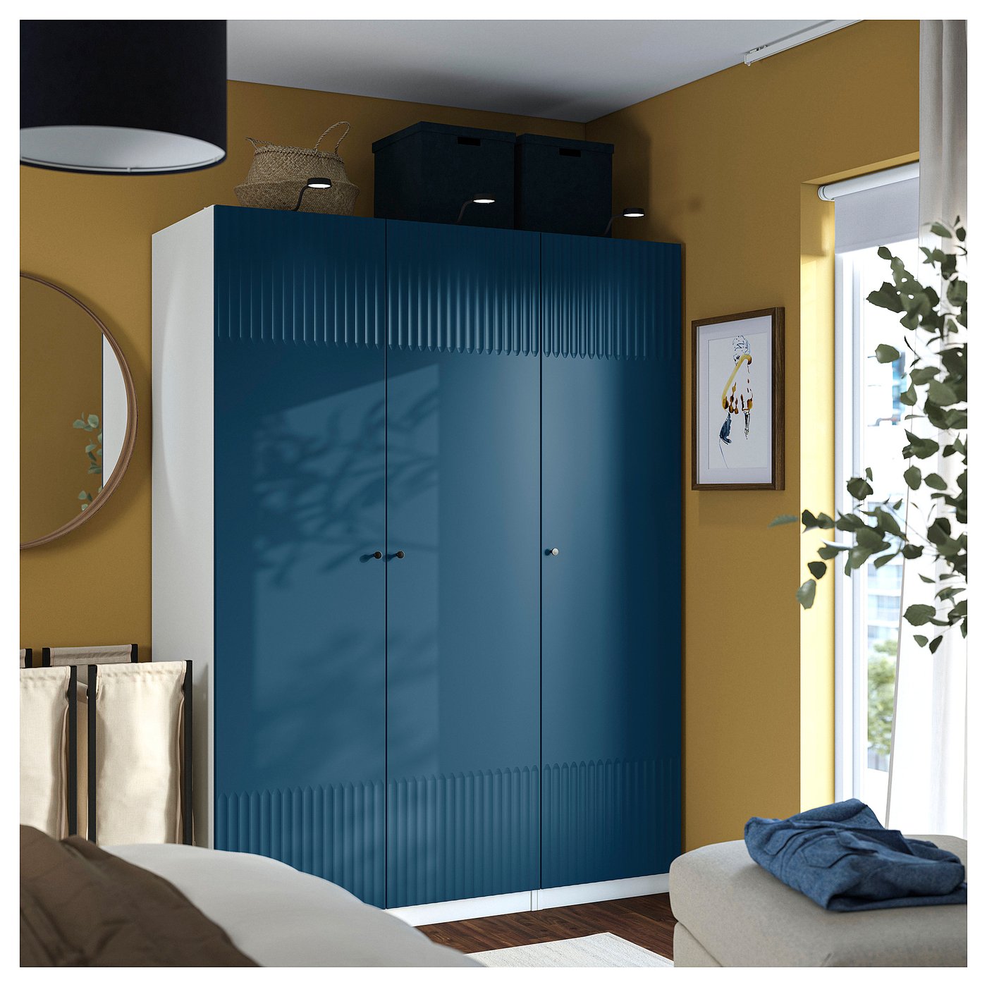 Modern bedroom with tall blue PAX wardrobe, large bed, white mirror, and window plant.